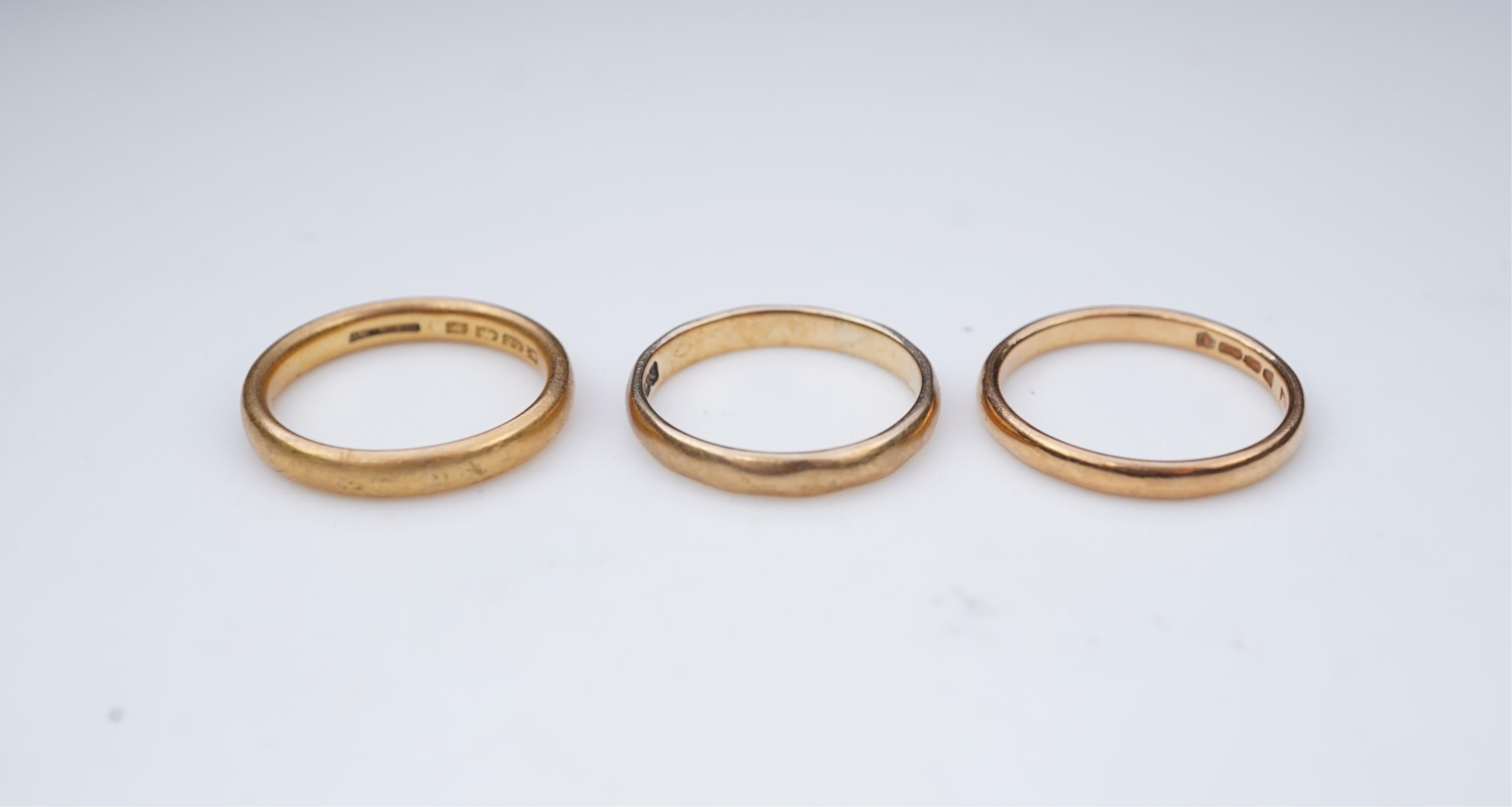 A collection of six gold wedding bands